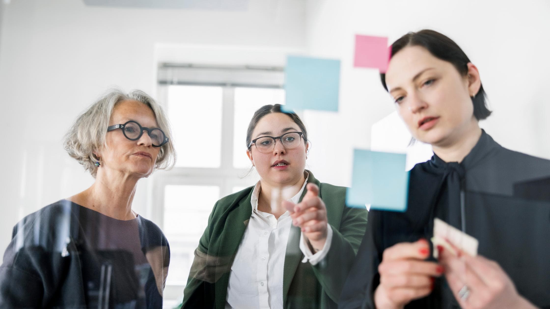 Female professionals planning strategy in a meeting at creative office.